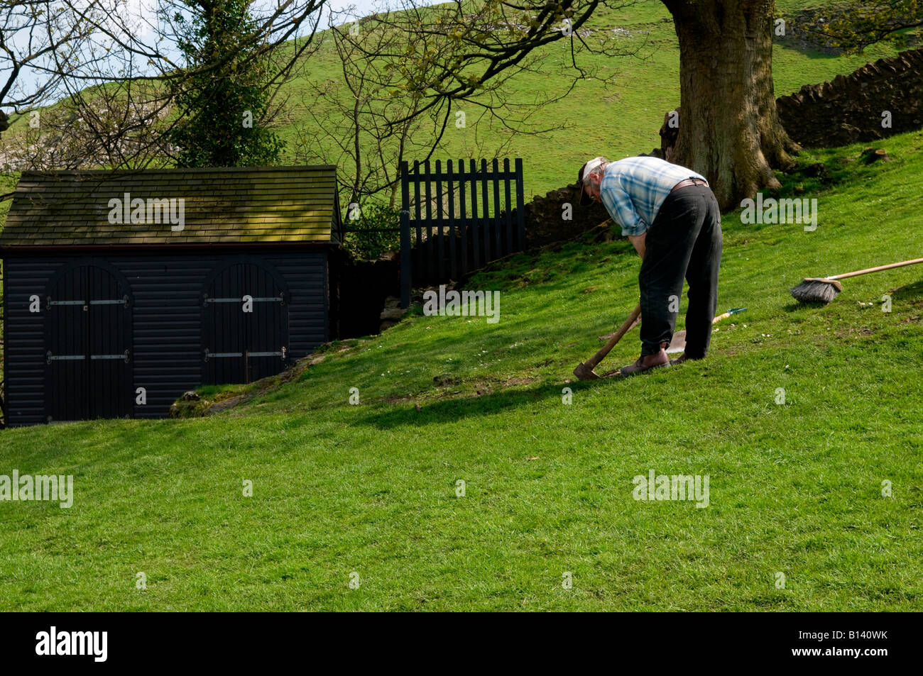 Man digging the ground at Peveril Castle Castleton Peak District ...