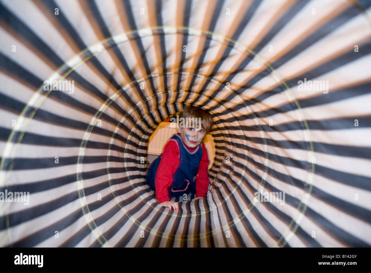 little child crawling through psychedelic tunnel Stock Photo Alamy