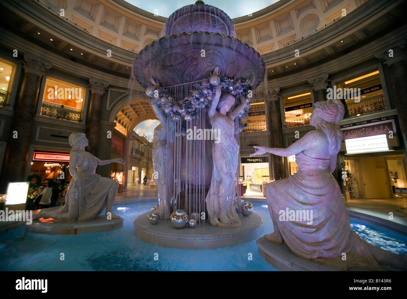 View on a fountain with statues in an indoor luxuous shopping center in