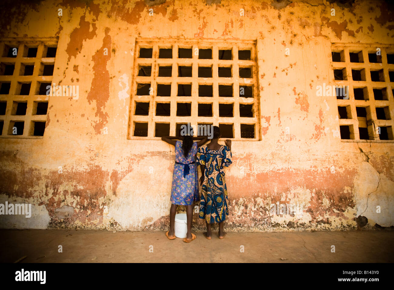 Girls look into the window of a classroom at the Idrissa Diouf primary school in Bignona Senegal on Tuesday June 12 2007 Stock Photo