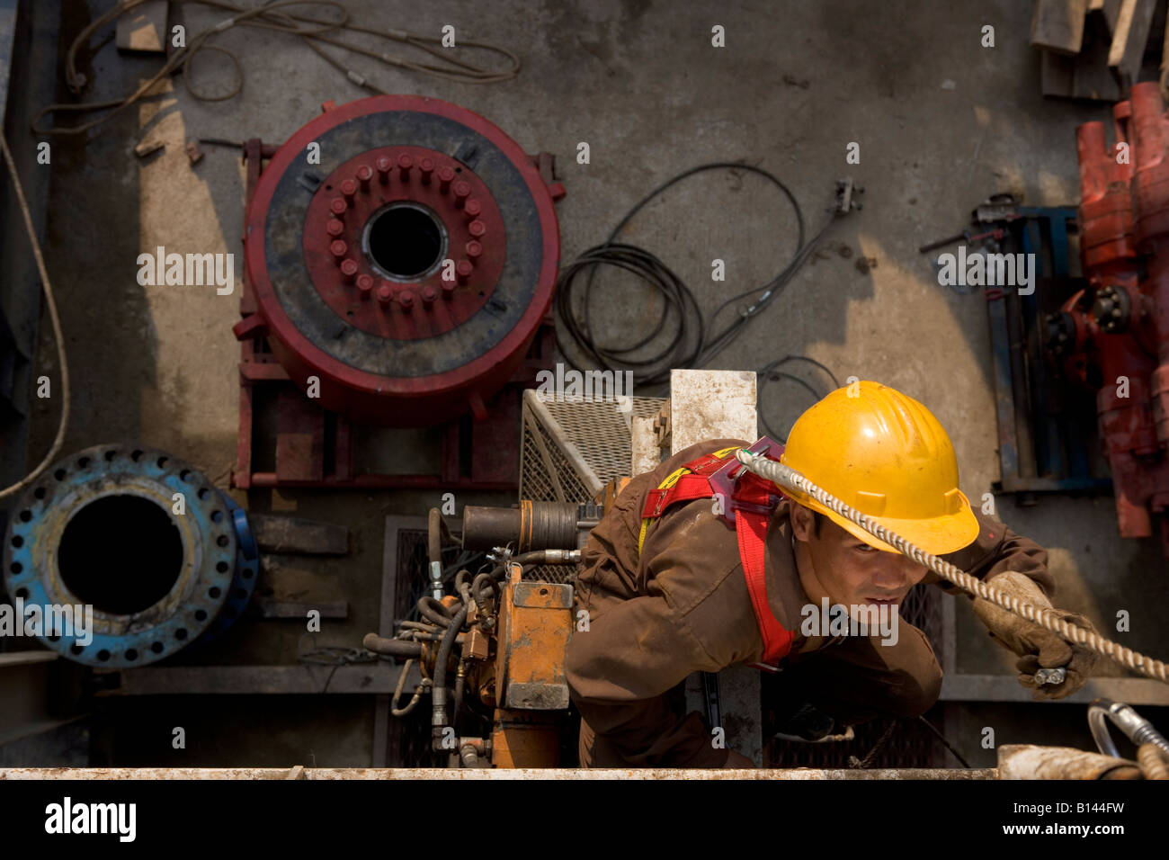 A worker on an oil rig. Lakkhi 1 Rig Site near Digboi, Assam, India ...