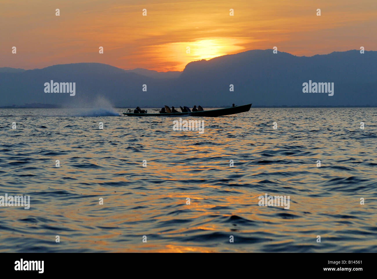 sunset on the Inle lake boat in front,  MYANMAR BURMA BIRMA, ASIA Stock Photo