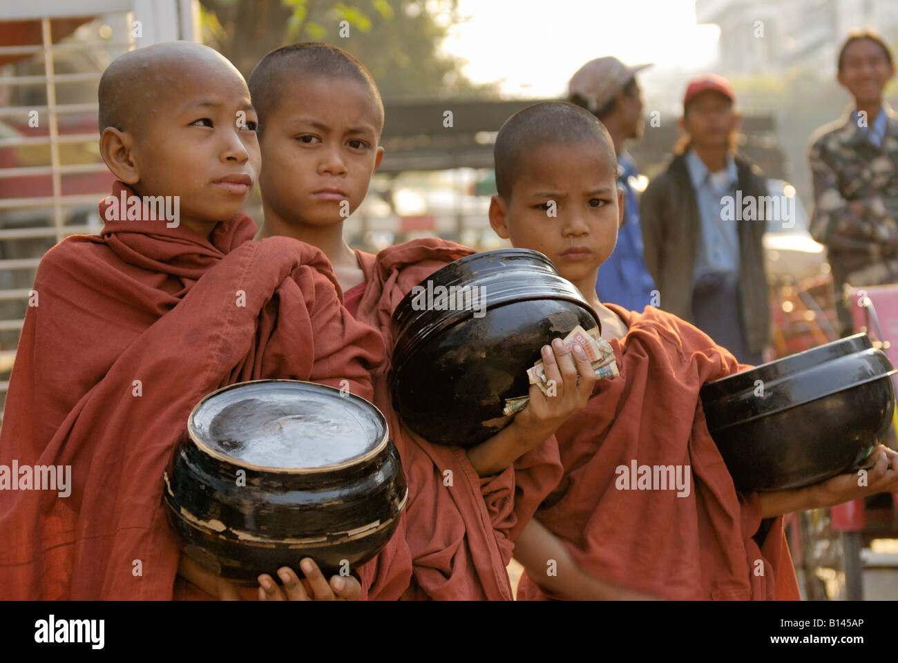 young monks collecting money or food, MANDALAY AMARAPURA, MYANMAR BURMA