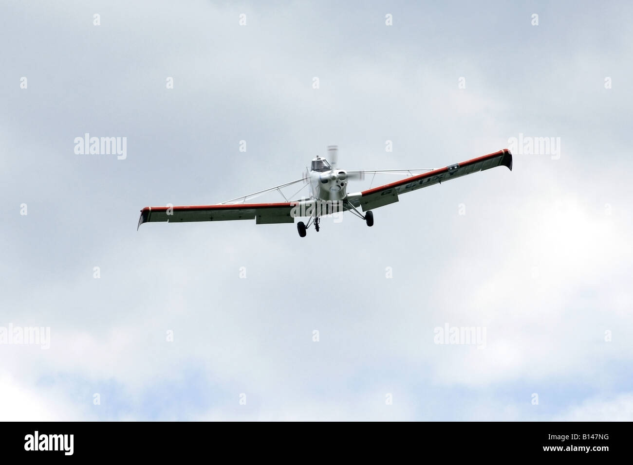 Crop spraying aircraft flies overhead on a reconn of a field Stock Photo