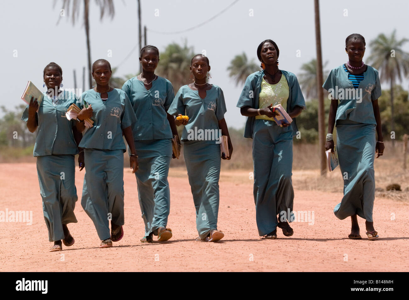 A group of students in school uniforms walk back from school near the village of Kabiline Senegal on Wednesday June 13 2007 Stock Photo