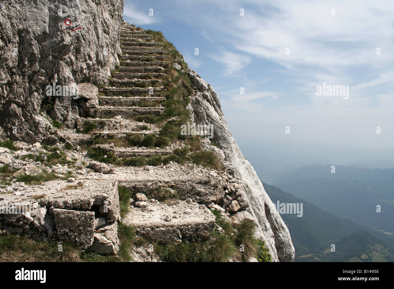 Steps cut into the rock that climb up to the Batognica Ridge near Mount Krn, Kobarid, Slovenia. Stock Photo
