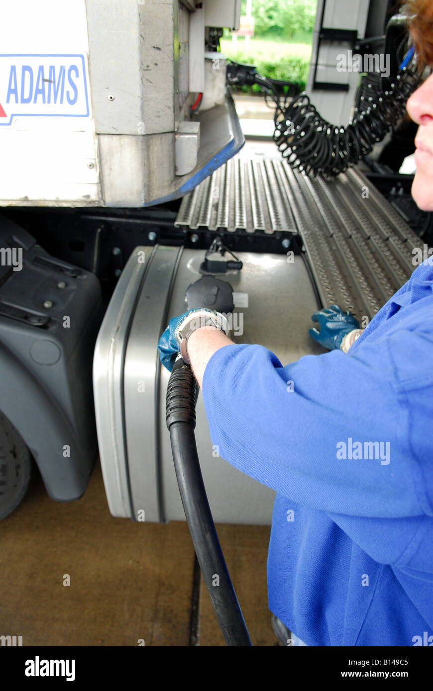 Hgv Driver Filling fuel tank at services. Stock Photo