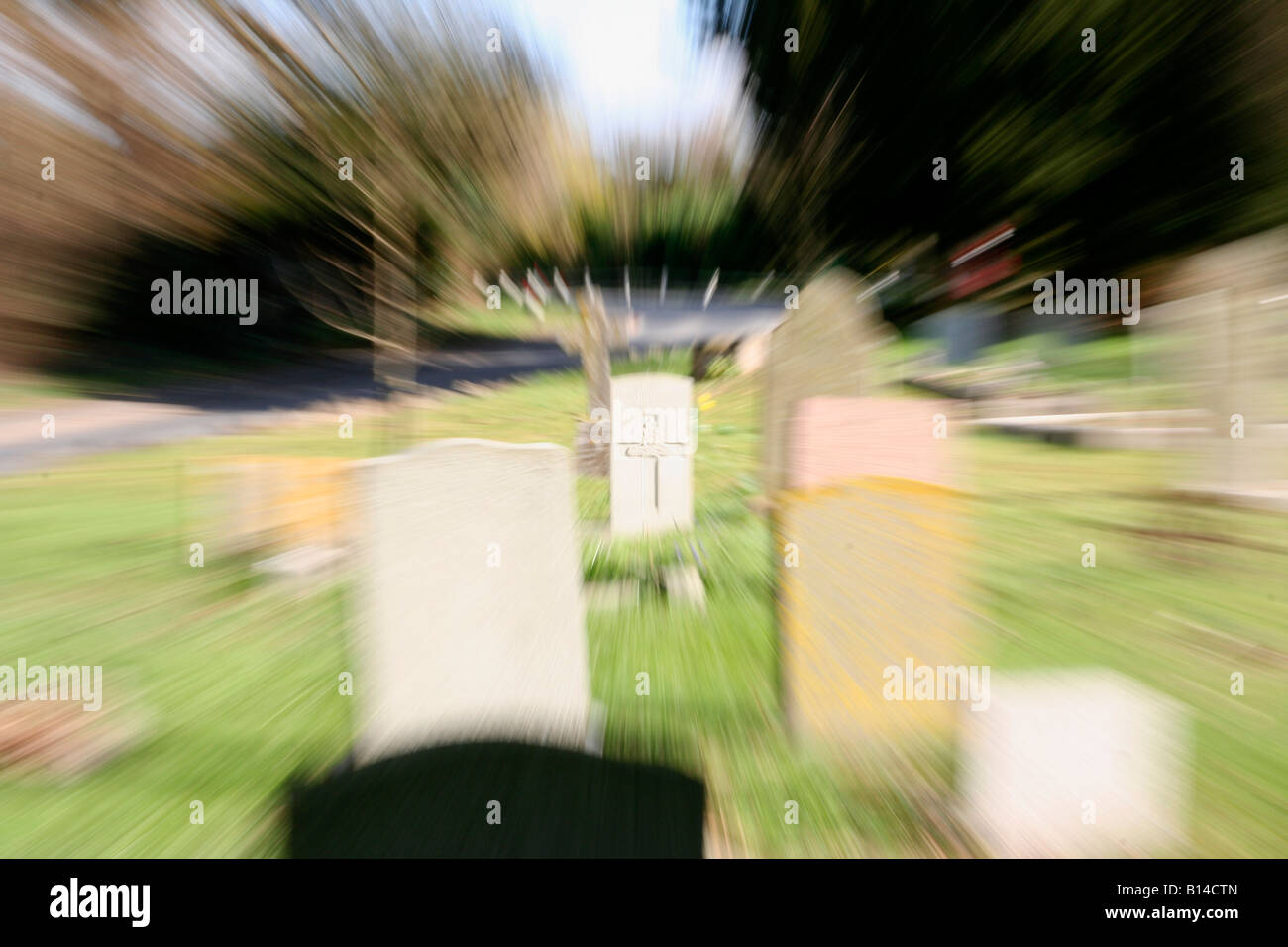 zooming in to a cematary headstone, represents racing headlong towards the end. Stock Photo