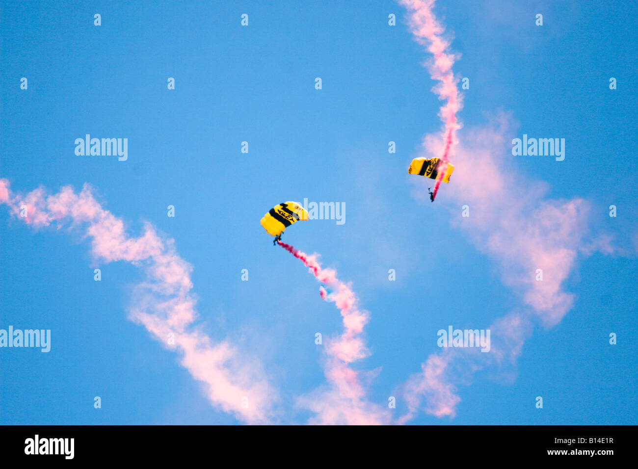 Members of the Golden Knights parachute team zip across the sky above