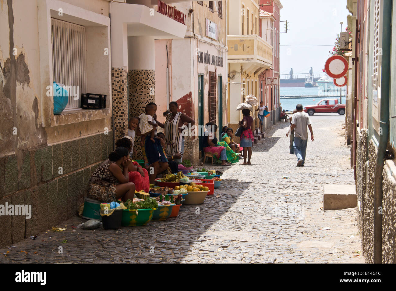 Women selling fruit and vegetables in the back streets of old Mindelo the capital of Sao Vicente one of the Cape Verde Islands. Stock Photo