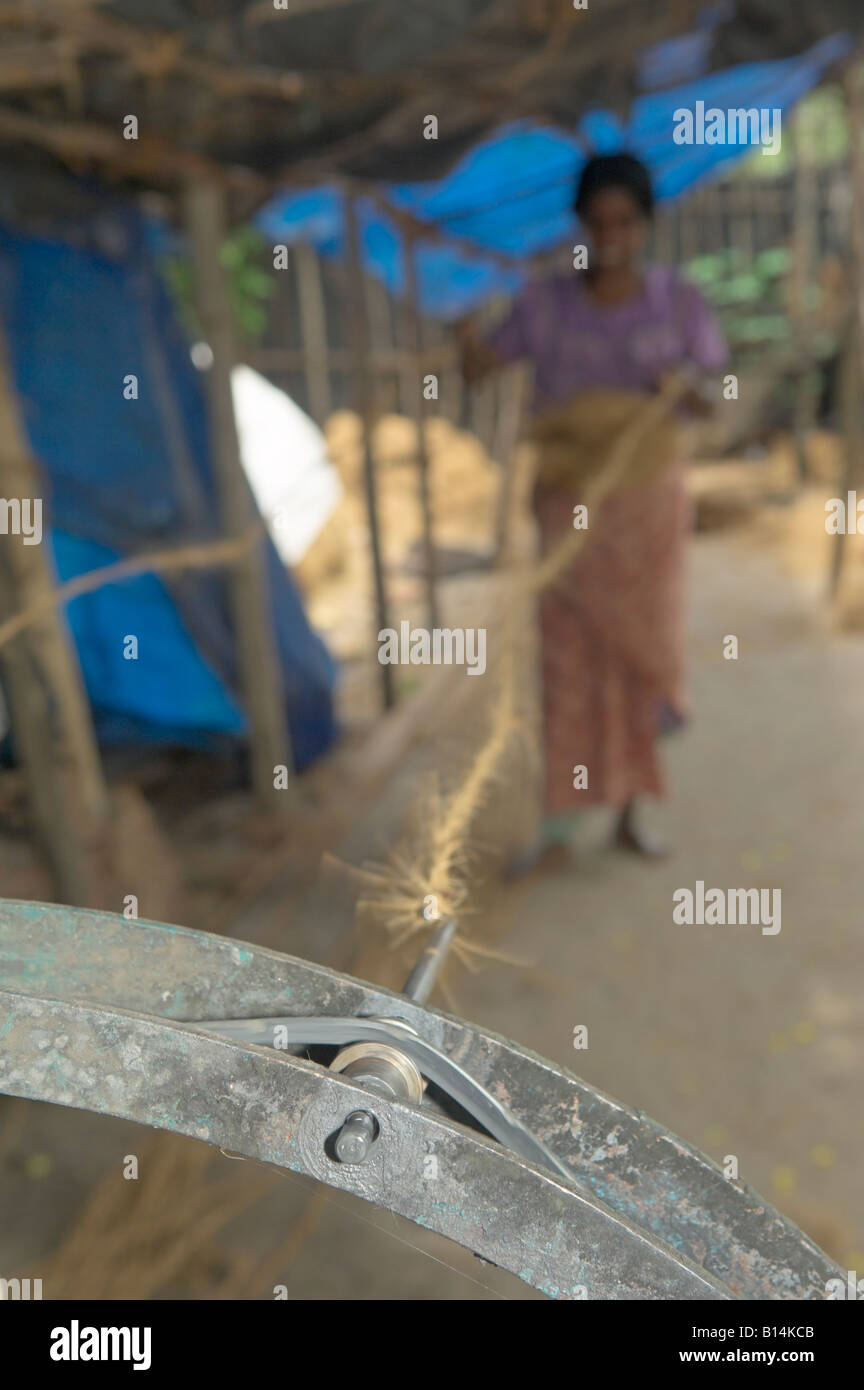 Coir twin production Woman backing away from spinning machine to ...