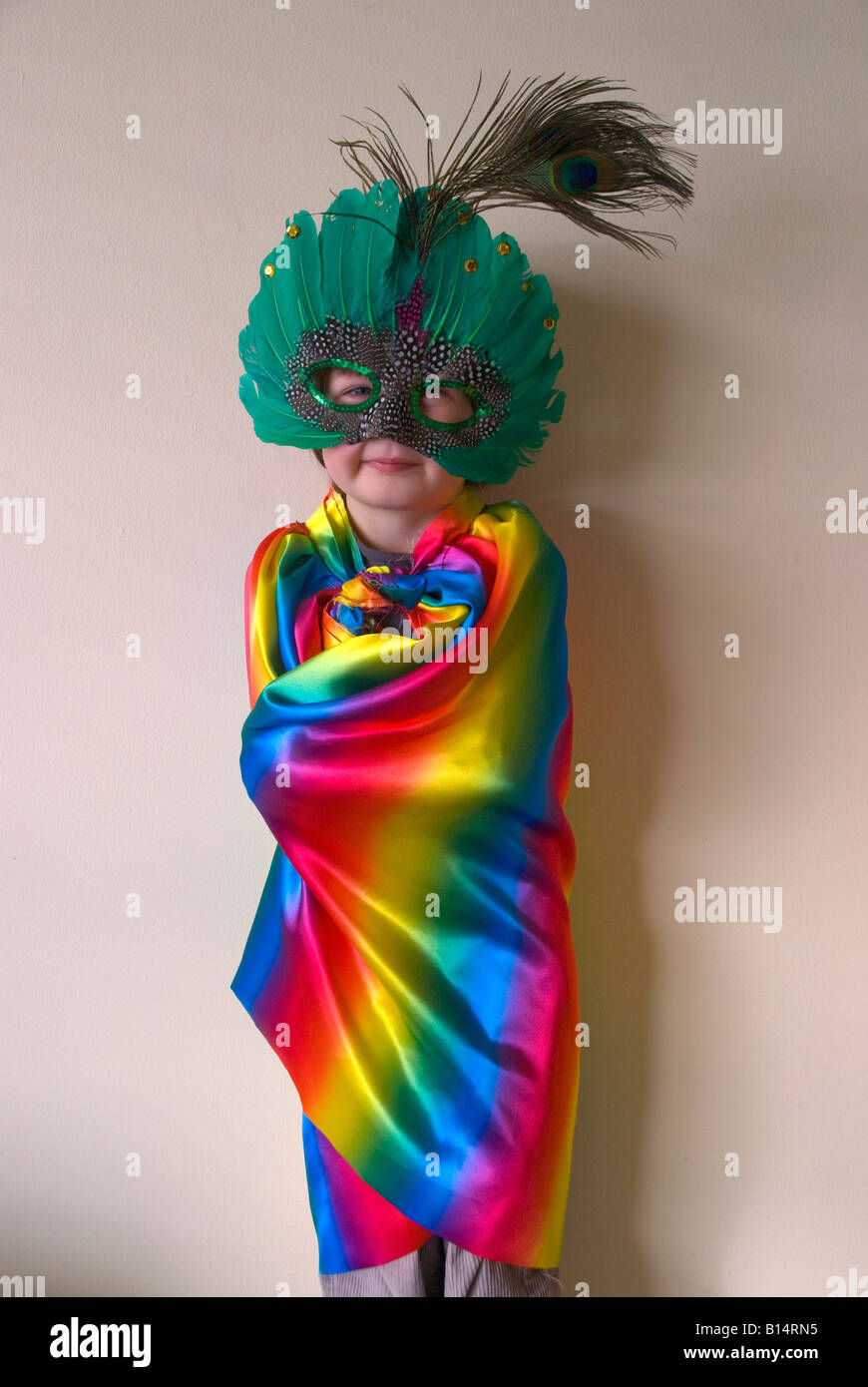 A boy wearing fancy dress a rainbow 