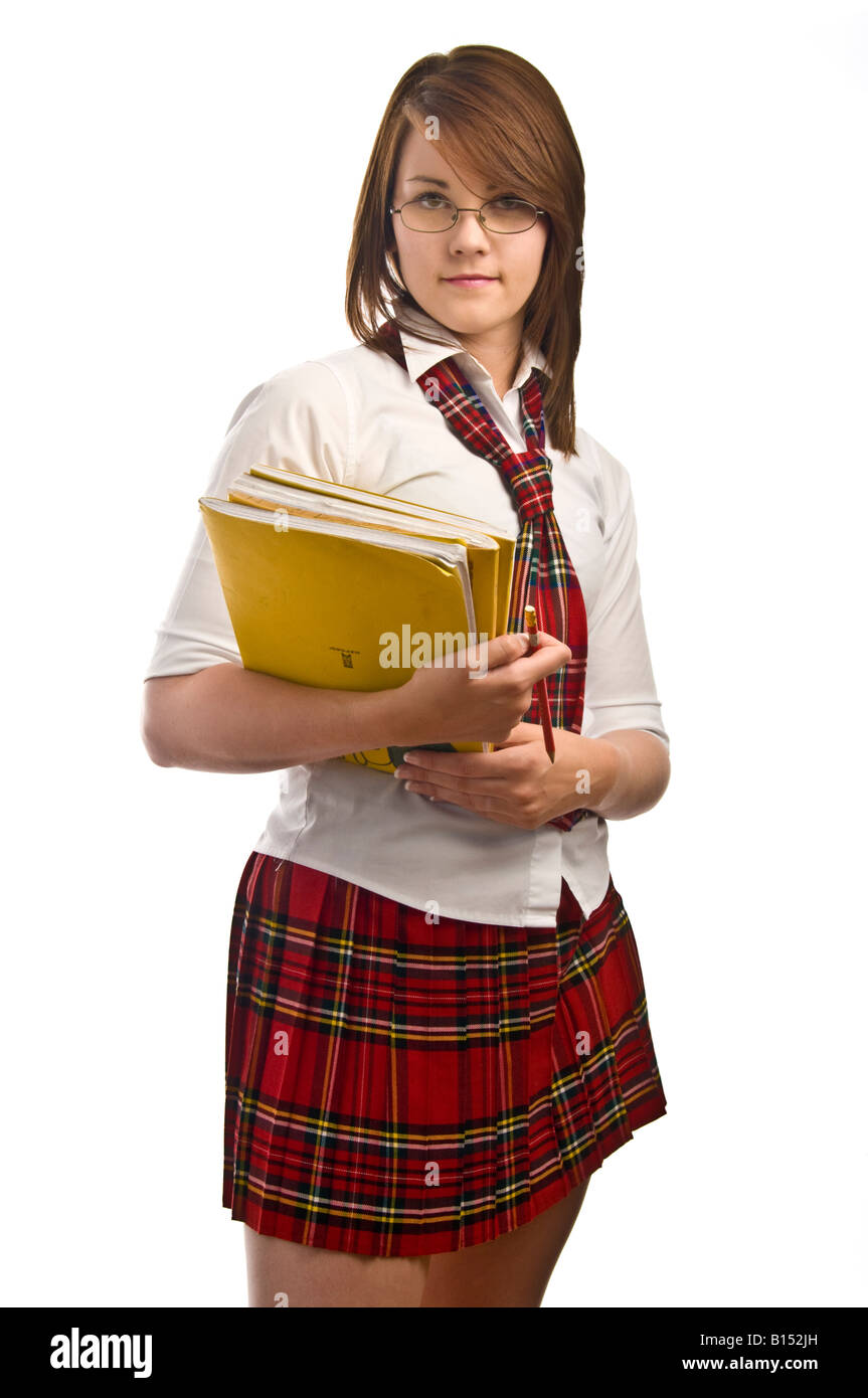 Teenage girl in American style school uniform against white background holding notebooks Stock Photo