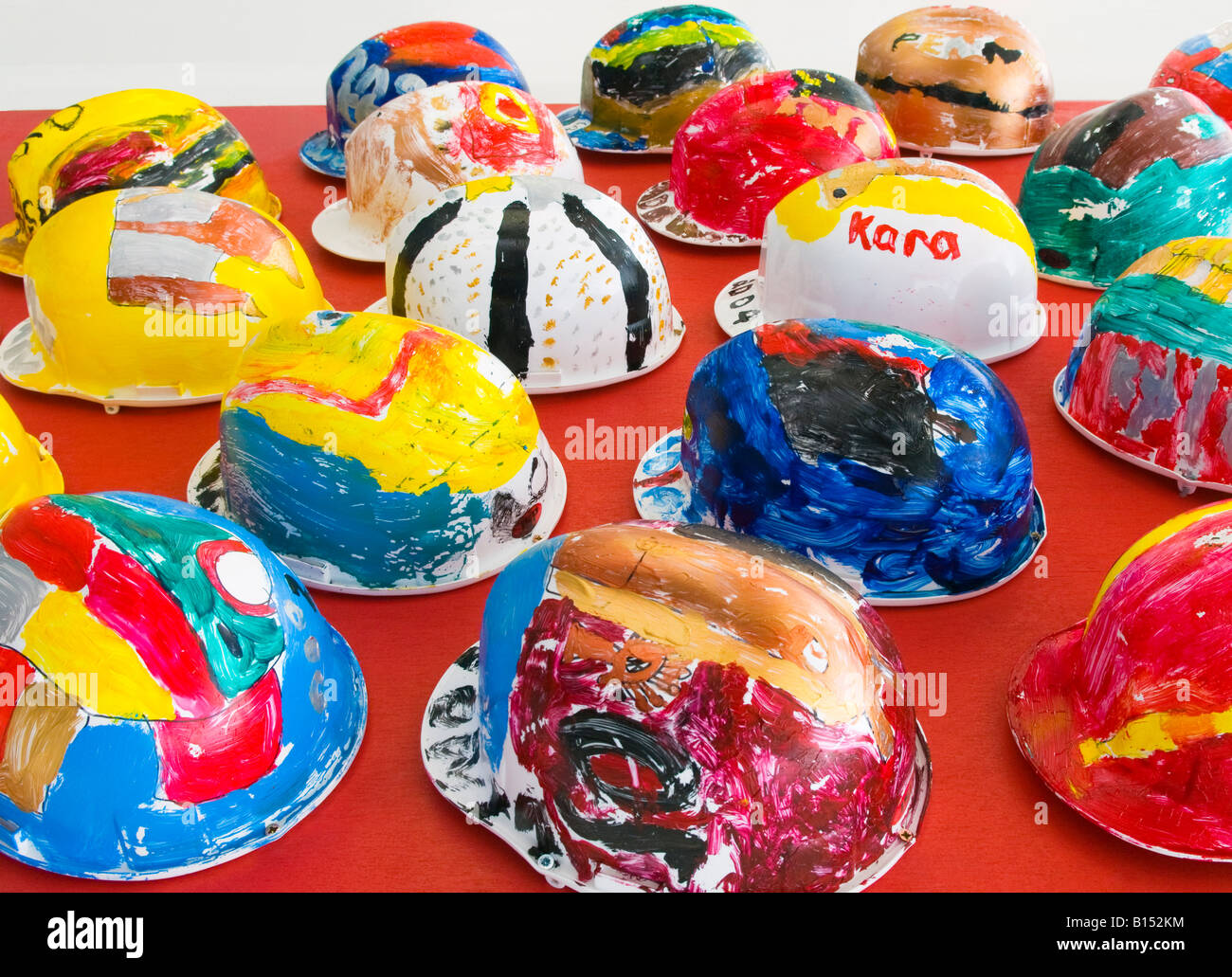Hand painted workmen's hard hats on display as public fine art, very bright  and colorful Stock Photo - Alamy