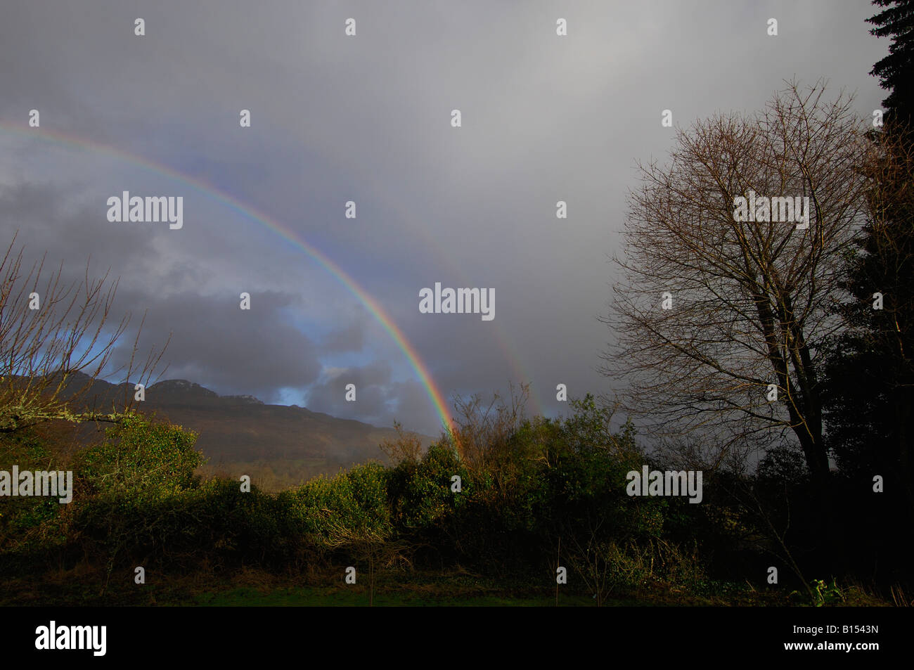 Rainbow against dark clouds hi-res stock photography and images - Alamy