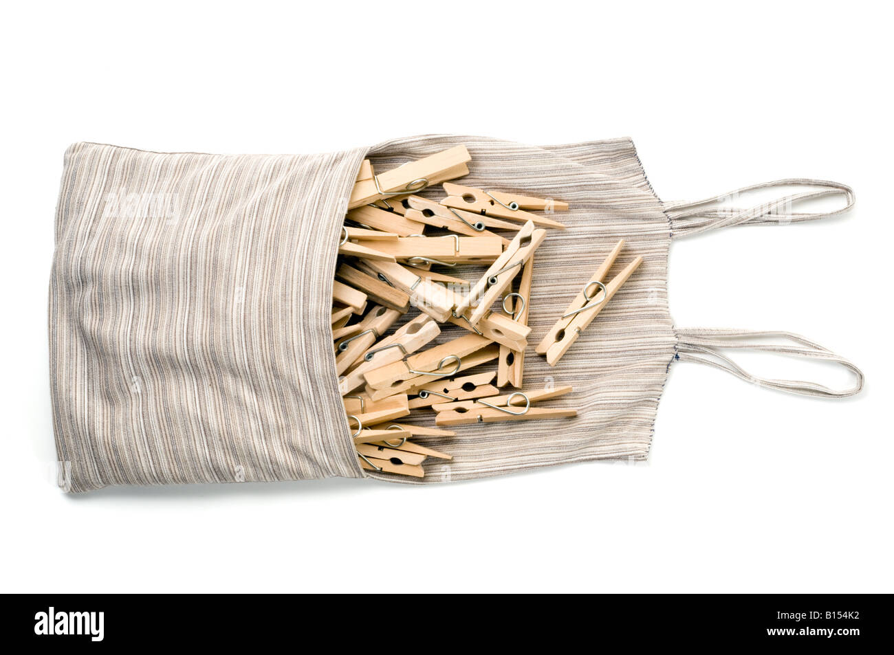 Wooden clothes pegs in a homemade cloth bag Stock Photo