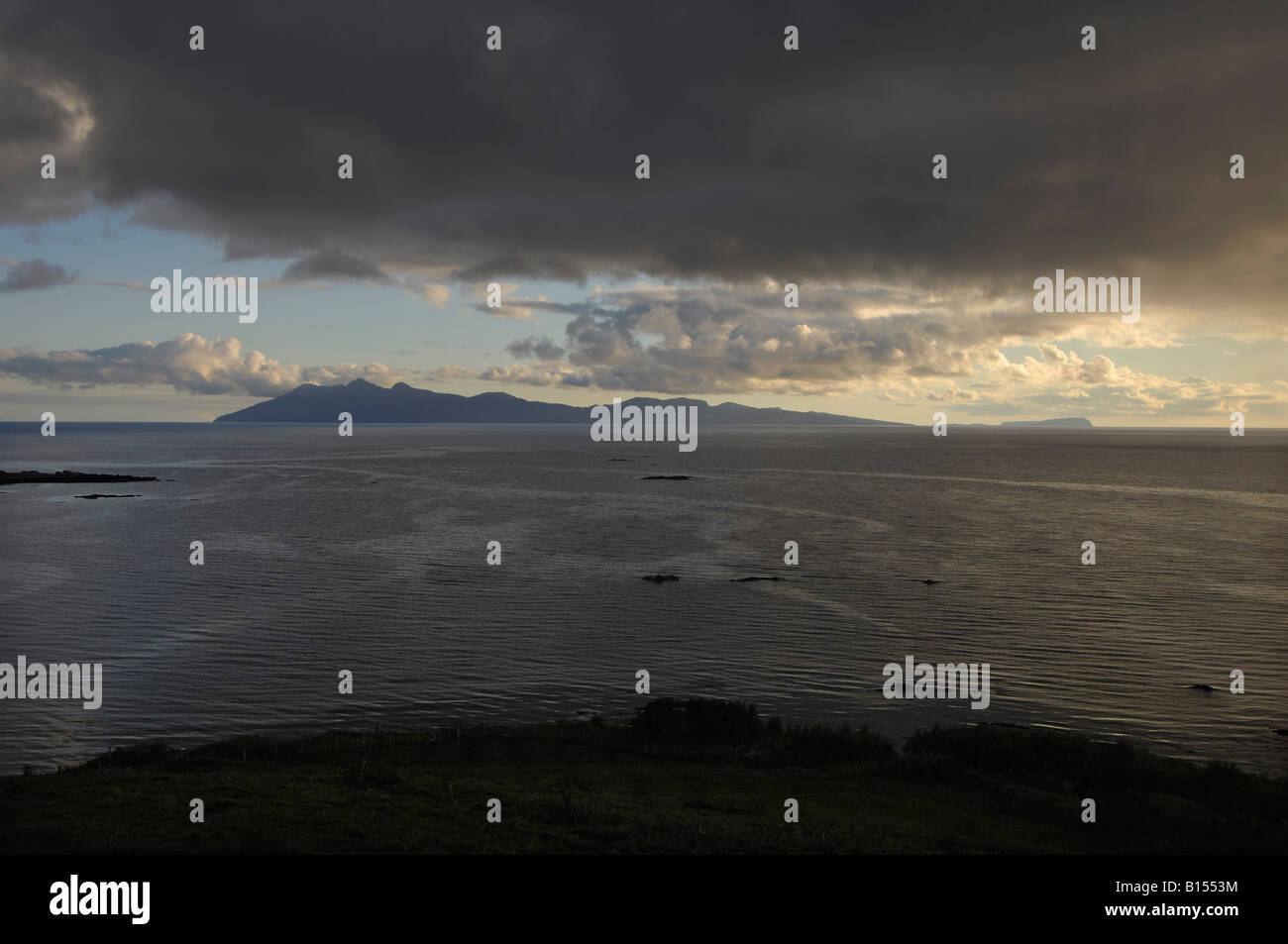 The island of Rum in evening light from Tarskavaig on the Isle of Skye ...