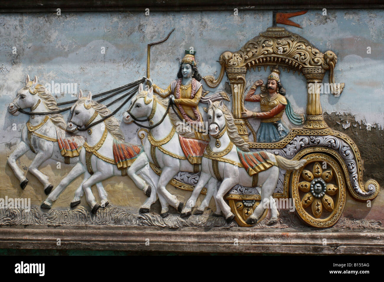 Mural on Hindu temple wall showing Arjuna and Krishna in their chariot , Kurukshetra war , India Stock Photo