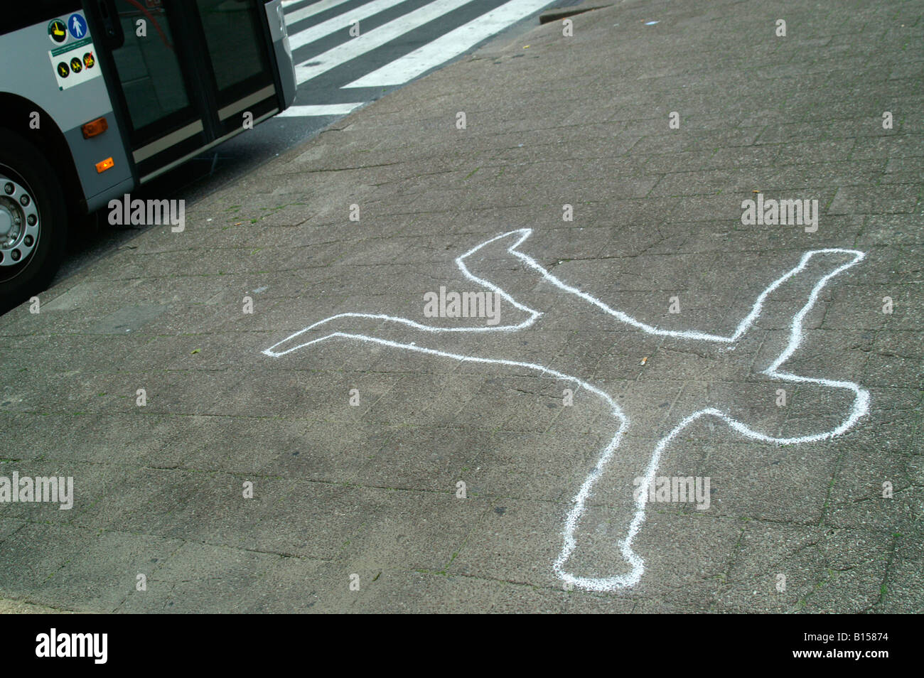 Chalk outline man figure body silhouette drawing fallen injury accident on pavement ground dead corpse bus stop traffic police Stock Photo
