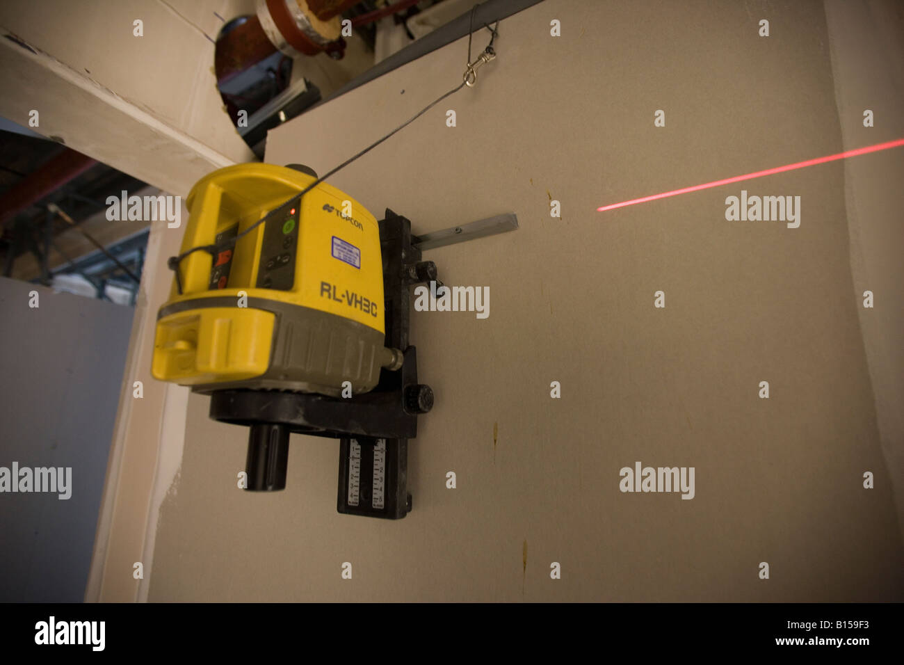 A laser leveller is mounted to check the alignment of a fitting. Stock Photo