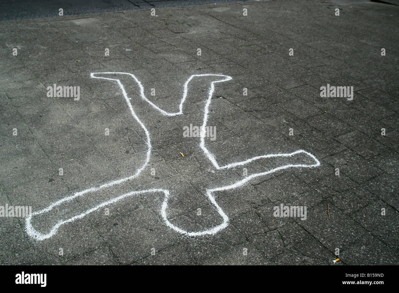 Chalk outline man figure body silhouette drawing fallen injury accident on pavement ground dead corpse Stock Photo
