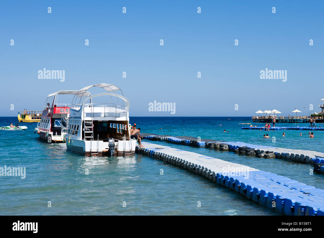 Glass Bottom Boats moored at a floating jetty, Naama Bay Beach, Sharm
