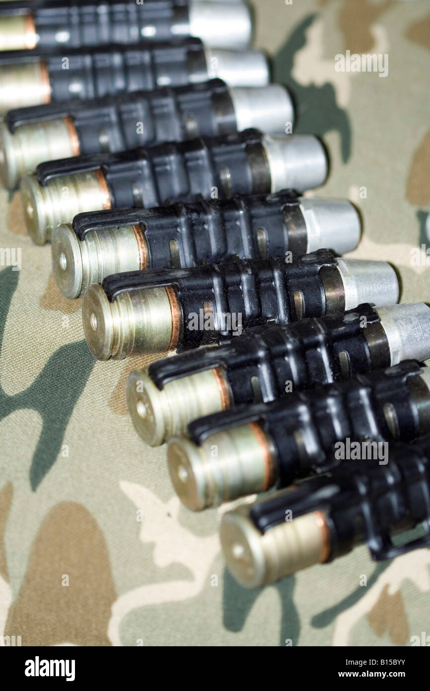 Flare pistol shells in a tape over the military fabric Stock Photo