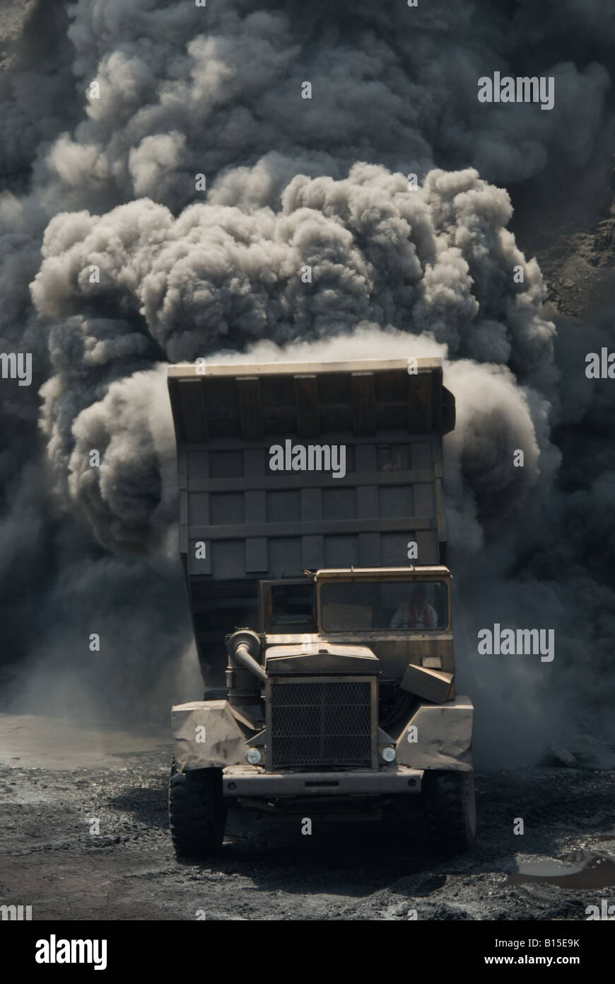 A truck accidentally loaded with burning coal from the seam dumps its