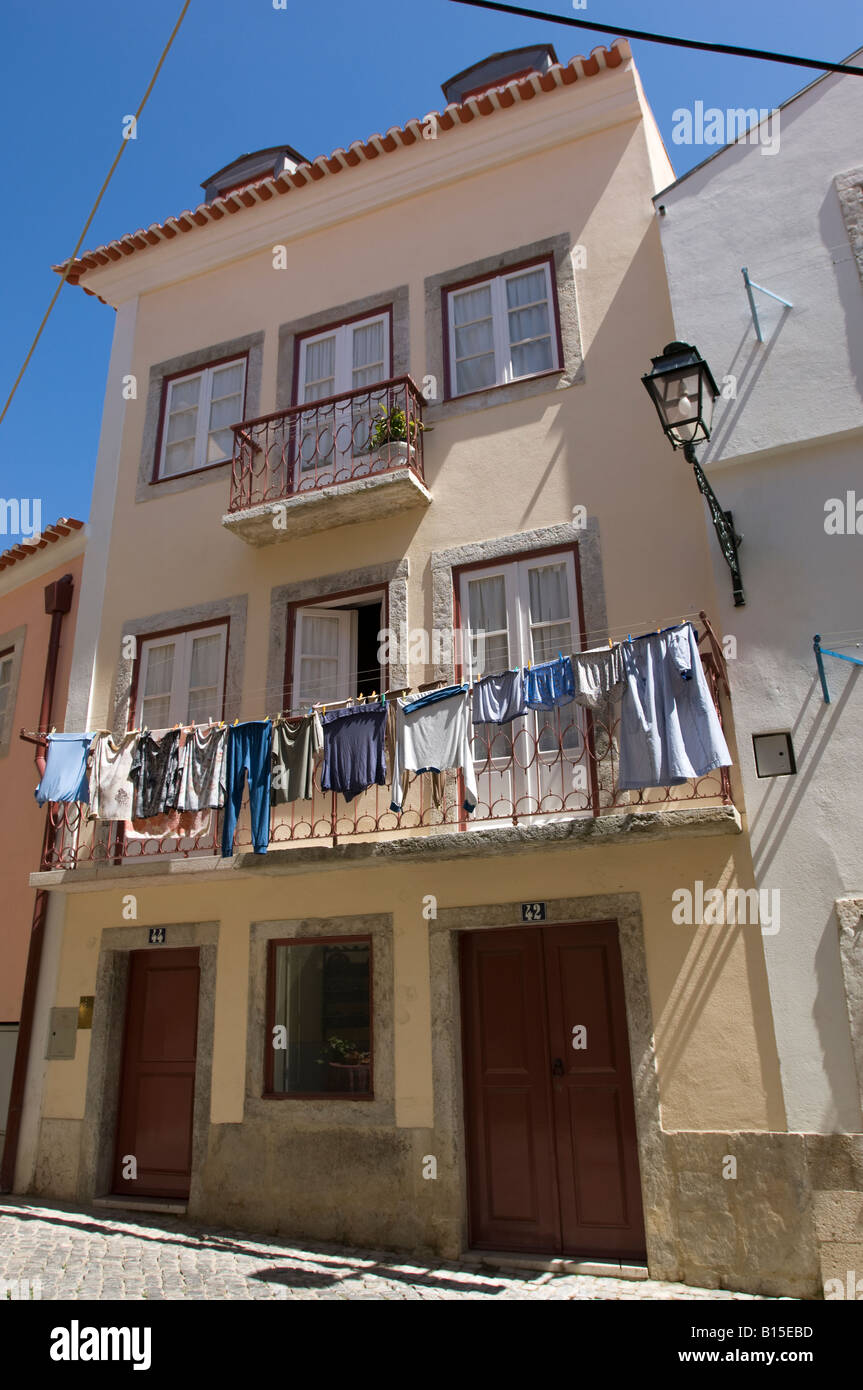 Laundry hanging out to dry and colourful house. Lisbon, Portugal Stock