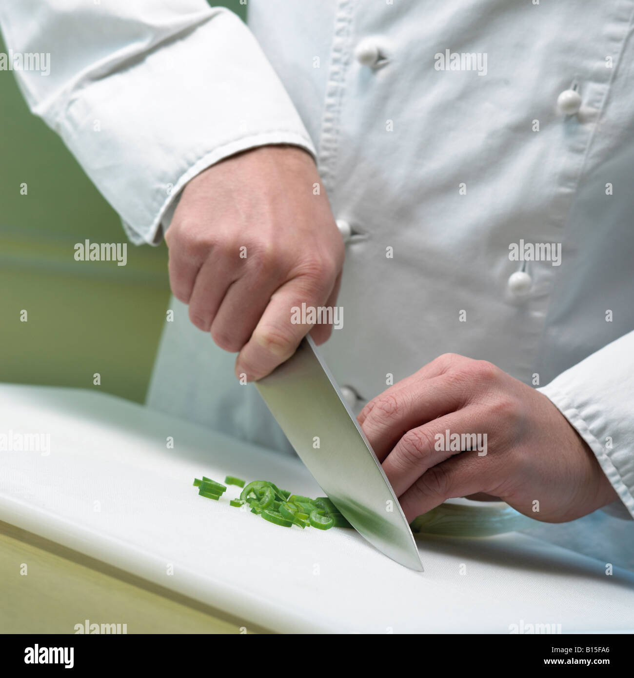 cook is cutting leek close up hands and knife Stock Photo