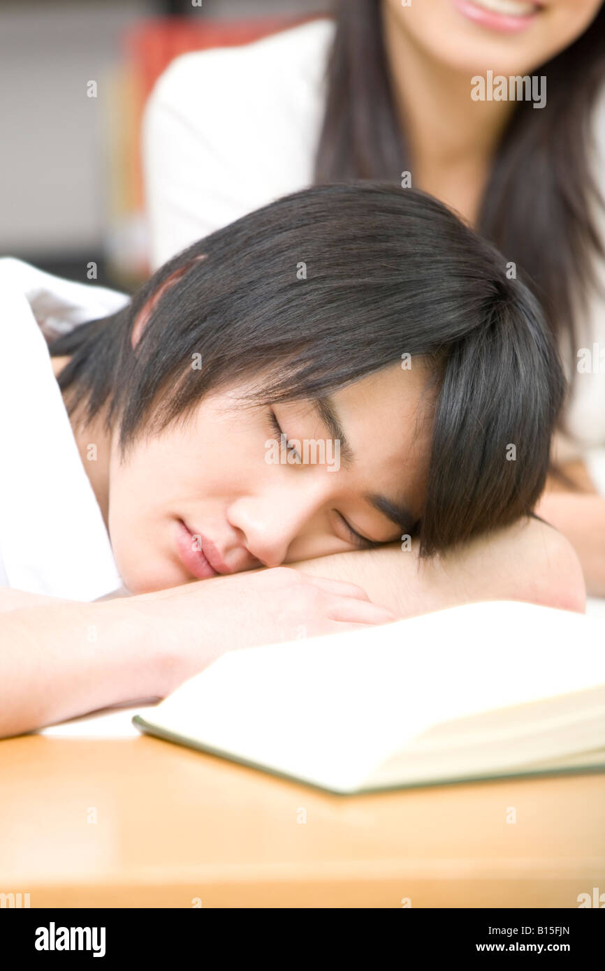 Japanese student sleeping on a desk Stock Photo Alamy