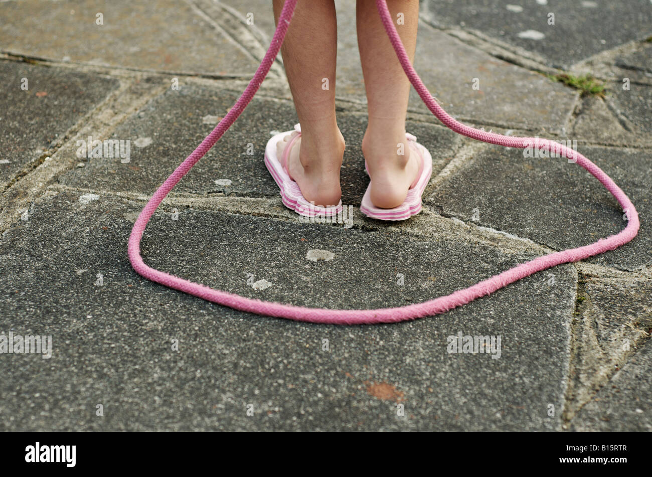 Child with pink skipping rope Stock Photo