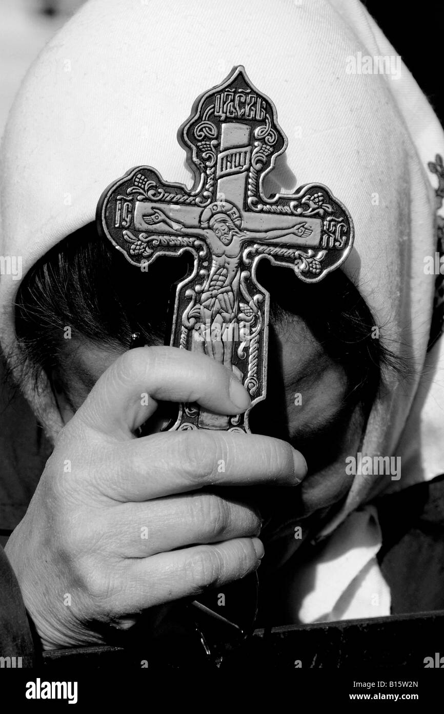 A Greek Orthodox Chrisitan pilgrim waits for an annual mass-Baptism ceremony in the River Jordan Stock Photo