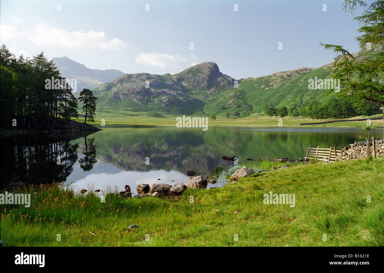 View of Blea Tarn showing the Langdale Pikes in the distance Stock Photo