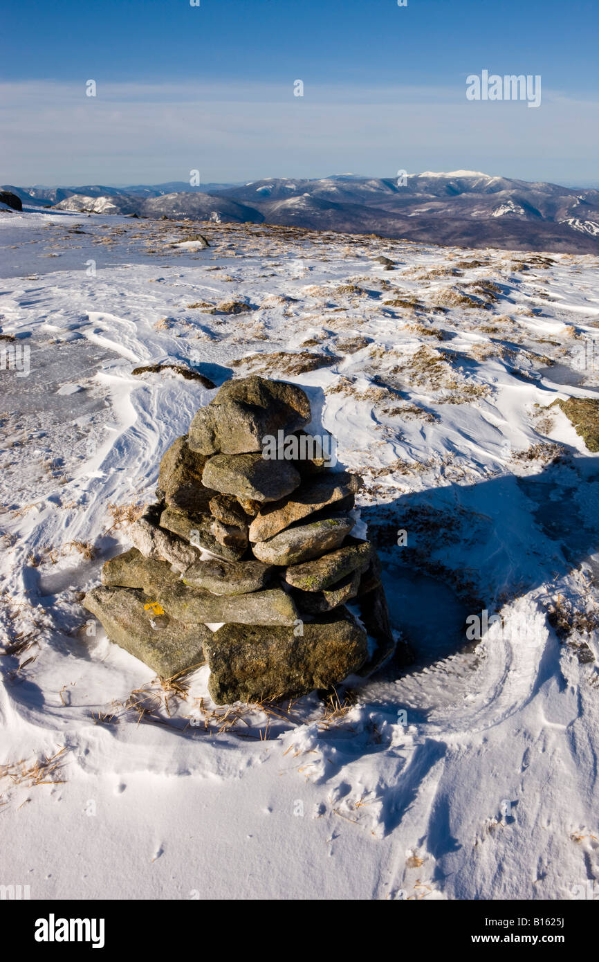 Wind scoured snow leads to a view of Mount Lafayette from Mount Clay in New Hampshire's White Mountains. Stock Photo