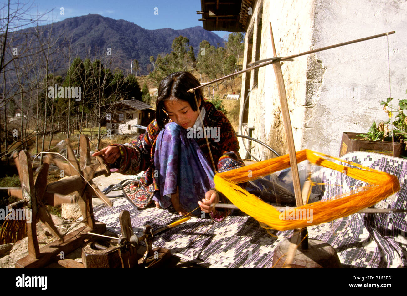 Bhutan Trongsa crafts girl spooling wool for weaving Stock Photo