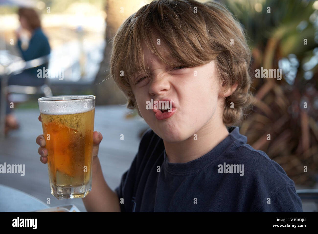 Juvenile drinking beer travel child childhood hires stock photography