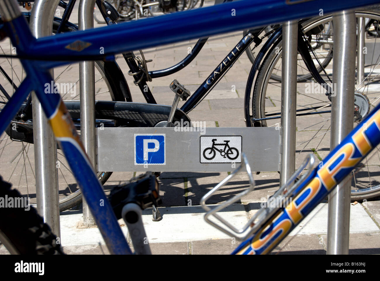 cycles parked on council racks with cycle parking signs, in kingston