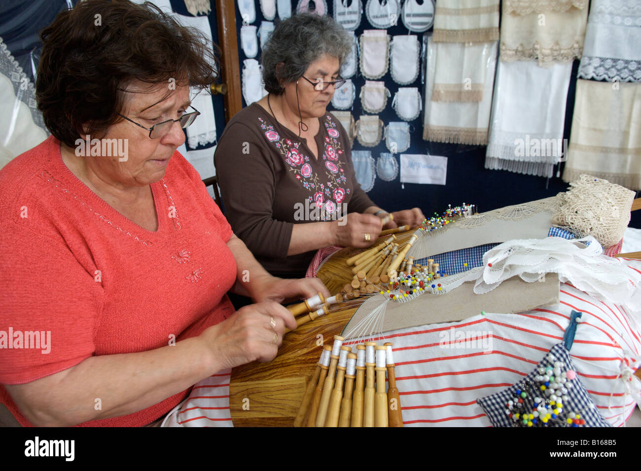 Spanish women weaving lace on their gingham pin cushions in the village