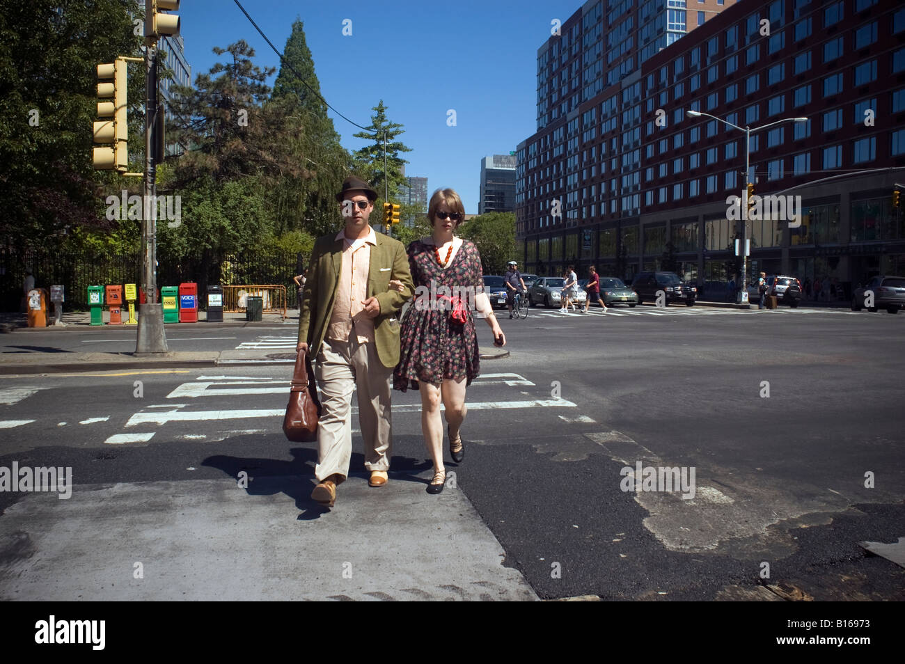 Hip Lower East Side couple crosses the Bowery at Houston Street Stock Photo