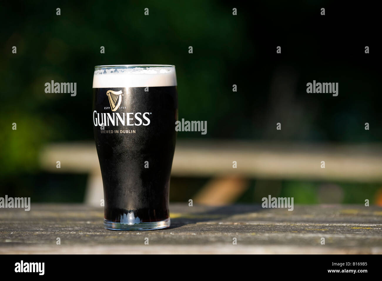 Pint of Draught Guinness on a pub garden table. UK Stock Photo
