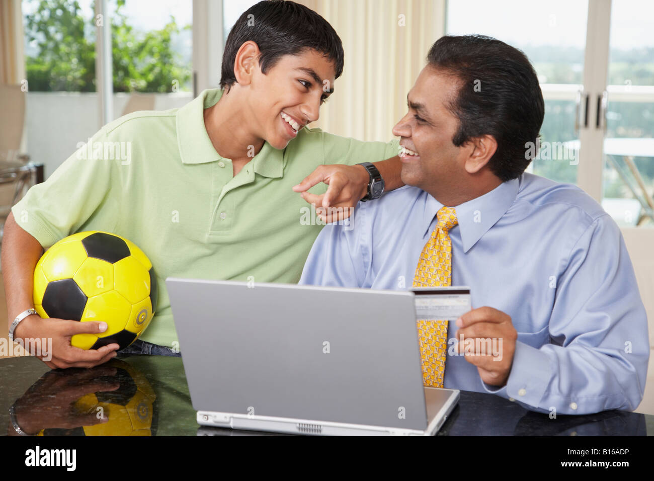Middle Eastern father and son shopping online Stock Photo
