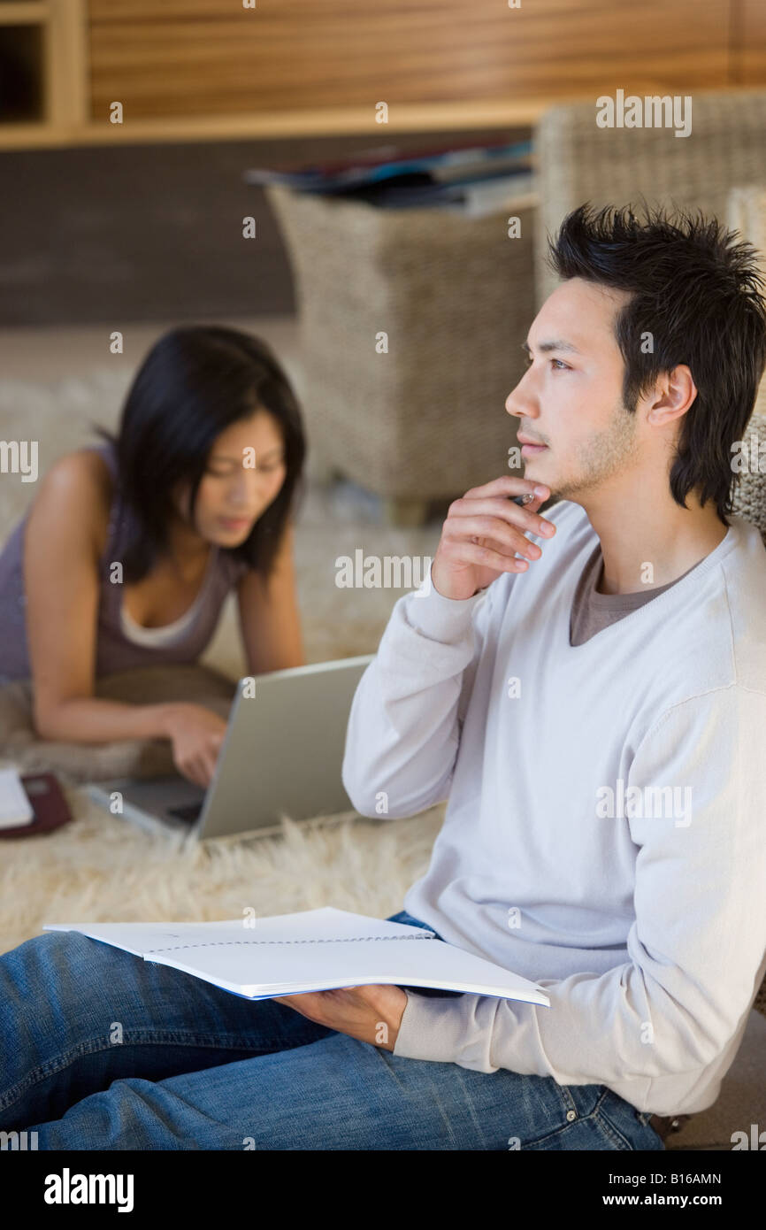 Couple laying carpet at home hi-res stock photography and images - Alamy