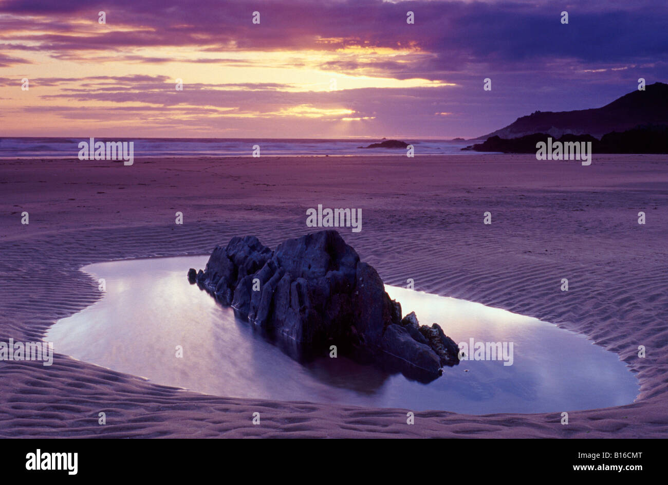 Rockpool on a beach in North Devon, UK, at sunset Stock Photo