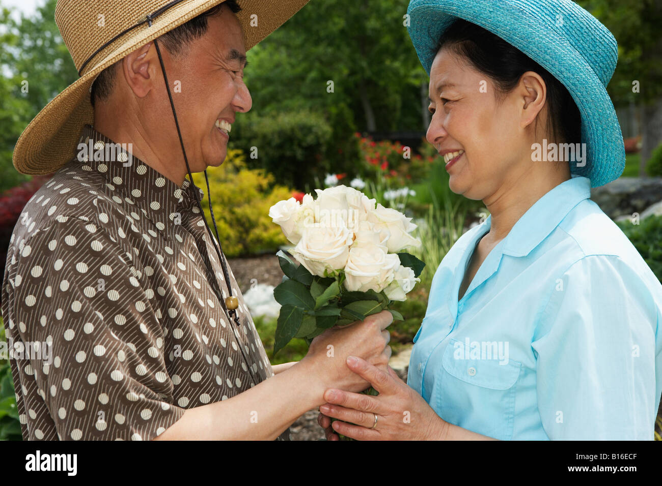 Senior Asian man giving flowers to wife Stock Photo Alamy