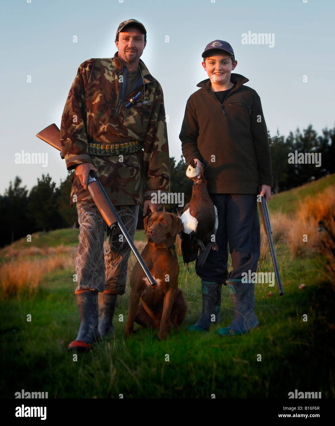 father and son out hunting in the country with dog Stock Photo