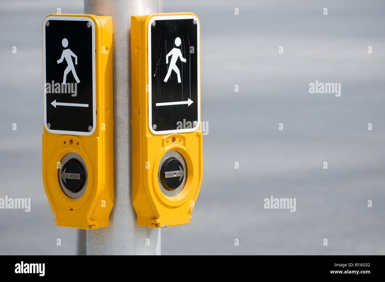 A crosswalk button at a traffic signal used by pedestrians Stock Photo