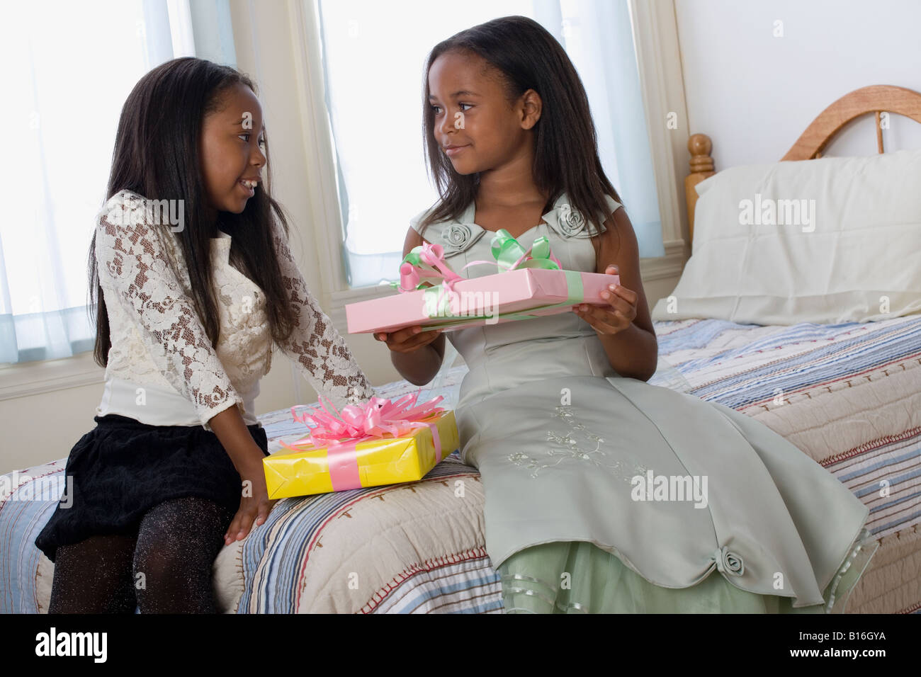 African American sisters exchanging gifts Stock Photo - Alamy