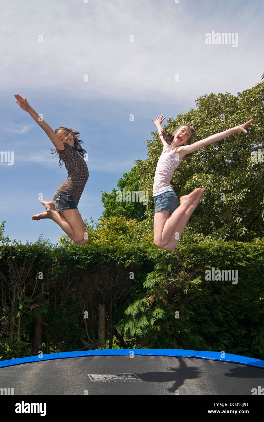 Happy Teens Jumping On Trampoline Friends Cheering Young 