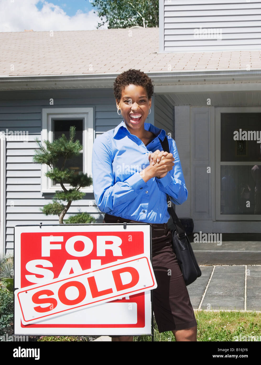 African American woman in front of new house Stock Photo - Alamy